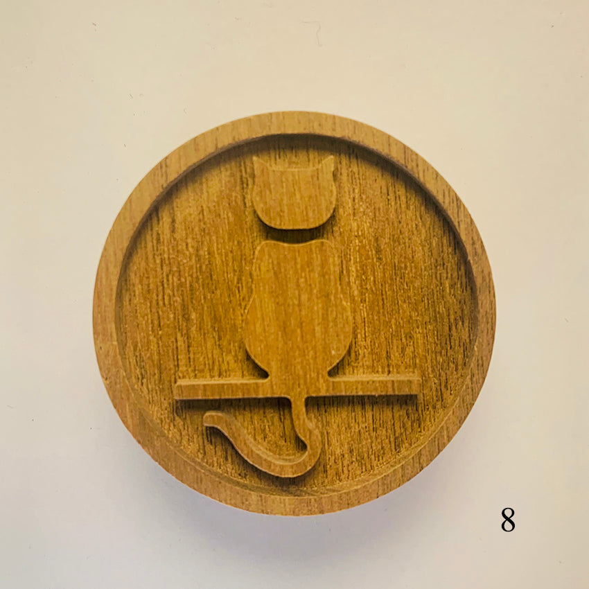 Wooden stamp with a cat design on a beige background