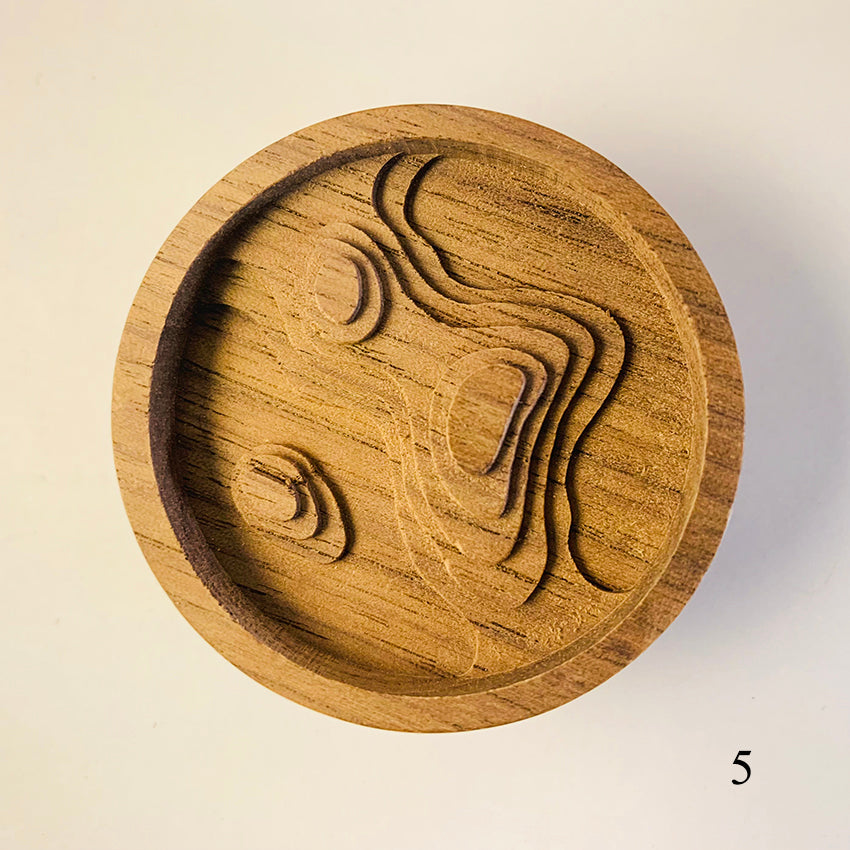 Wooden coaster with embossed design .