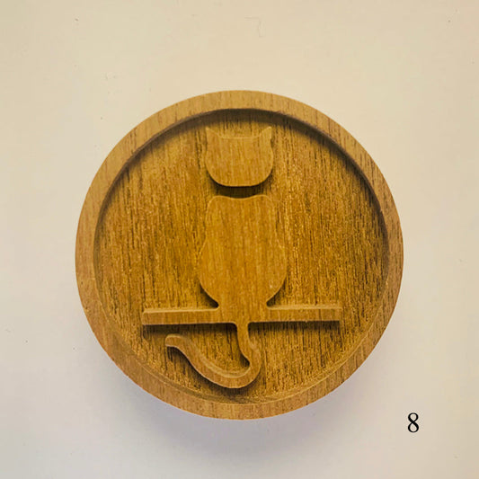 Wooden stamp with a cat design on a beige background
