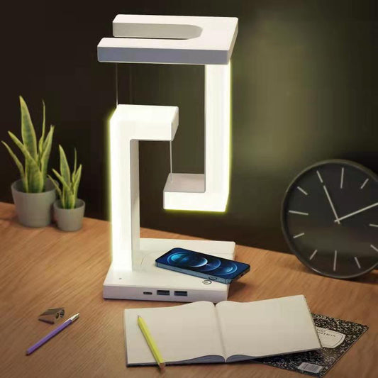 Modern desk lamp on a wooden surface with a phone, notebook, and clock in the background.